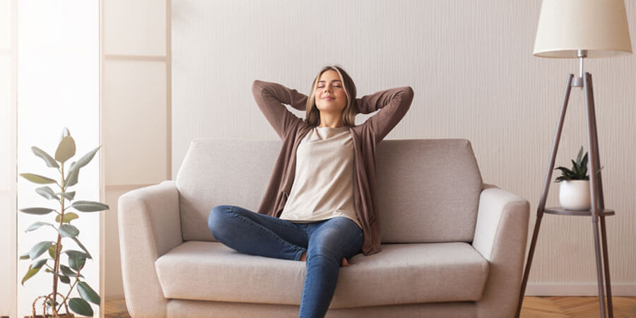 Woman relaxing on a coach breathing clean air